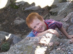 boy climbing rocks