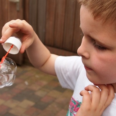 boy playing with bubbles (400x399)