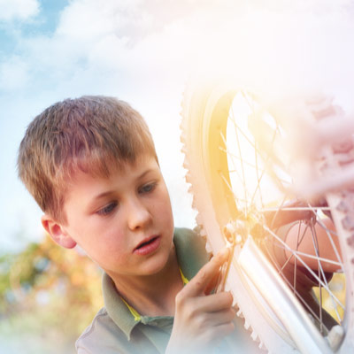 7-8-year-old-checking-tires-on-a-child-bike