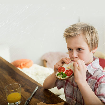 7-8-year-old-eating-a-sandwich-at-home