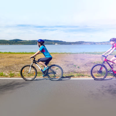 Teenager-biking-on-the-side-of-the-road-wearing-a-helmet