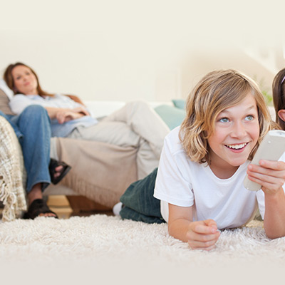 7-8-year-old-and-parent-on-blanket-watching-tv