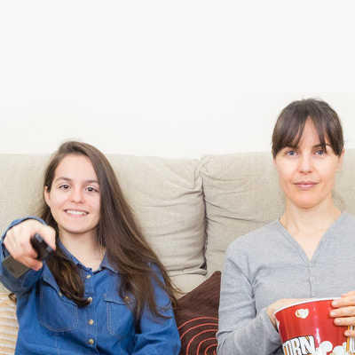 Teen-&-mother-watching-tv-together