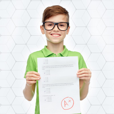 8-year-old-smiling-with-a-paper-from-school